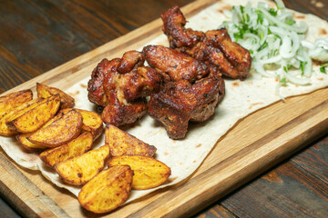 Grilled meat with potatoes and onion