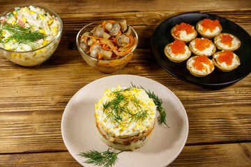 Set of various festive dishes on a wooden table