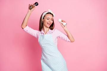 Portrait of her she nice attractive lovely pretty cute cheerful playful brown-haired housewife dancing with pepper having fun enjoying cooking isolated on pink pastel color background