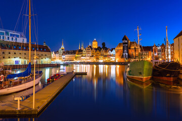 Naklejka na ściany i meble Historical port crane in Gdańsk over the Motlawa river at night, Poland.