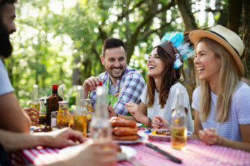 Small group of friends having fun at barbecue party