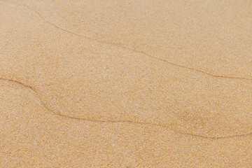 Waving pattern on sand beach background, nature texture background, outdoor day light