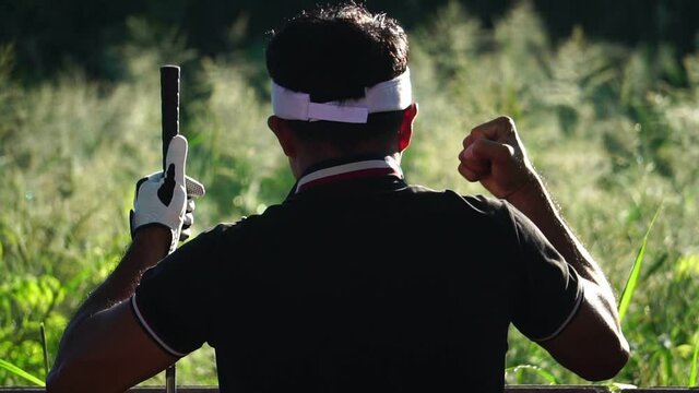 Footage Slow Motion: Male golfer happy with a warm light at sunset