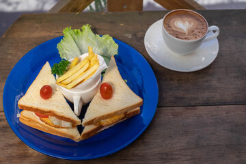 sandwich breakfast with hot drink on table
