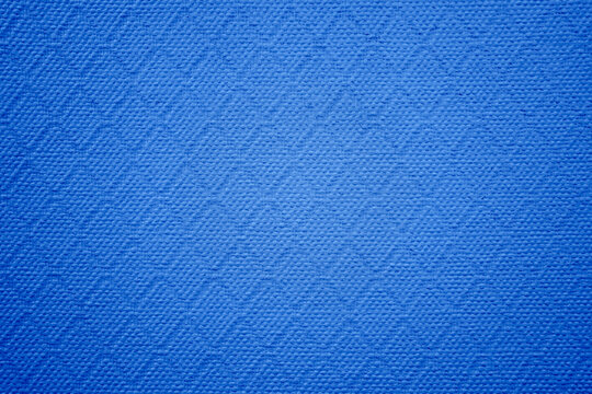 The image of textured blue background with rhombus pattern.