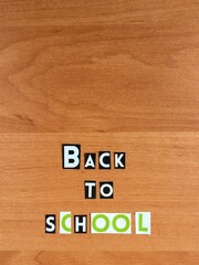 Obraz premium letters “back to school” cut from a magazine on a wooden background