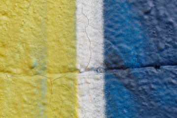 Fototapeta na wymiar Old Weathered Yellow, White and Blue Painted Concrete Wall Texture