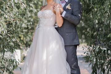 groom with bride on the road in the park
