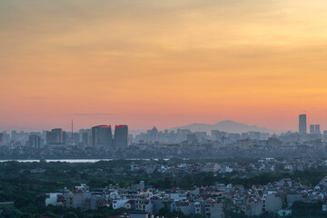 Fototapeta na wymiar Cityscape of Hanoi skyline at Vinh Tuy bridge over Red river during sunset time