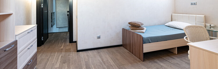 The bedroom in the apartment has a single bed, minimalist design