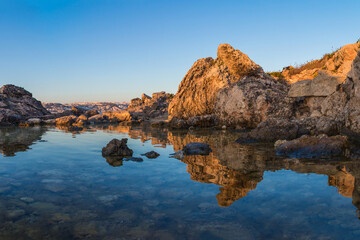 Fototapeta na wymiar Reflection of the Maltese Landscape at Sunrise 