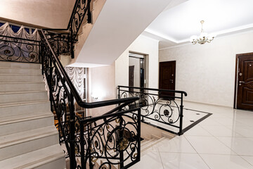 View of the elevator and stairwell in the entrance of a residential building