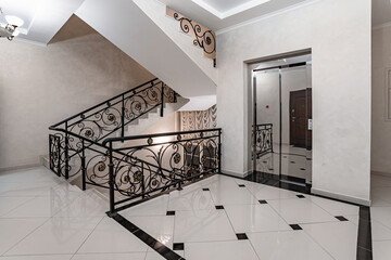 View of the elevator and stairwell in the entrance of a residential building