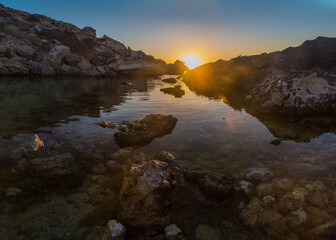 Colours of Slug's Bay at Dawn as the sea reflects the sky 