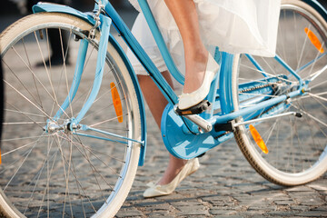 Fototapeta na wymiar Girl with white skirt on blue bicycle.