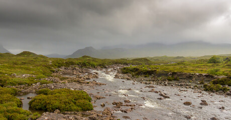 Naklejka na ściany i meble The fast flowing River Sligachan on a stormy day on the Isle of Skye, near Portree, Scotland