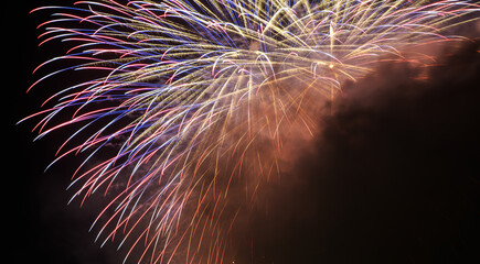 Colorful fireworks over city at night.