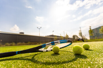 Tennis Racket on empty tennis grass court