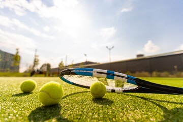 Tennis Racket on empty tennis grass court