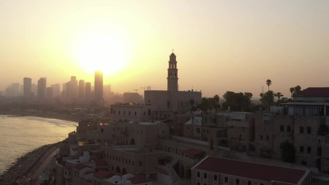 Aerial view of Jaffa old city port at sunrise with marina coastline and general view of both Jaffa and Tel Aviv.