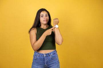 Young beautiful woman standing over yellow isolated background with advice gesture and pointing his...