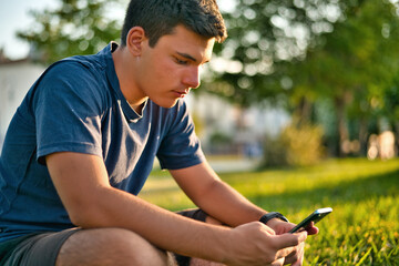 Teenage Boy Using Phone In Urban Setting
