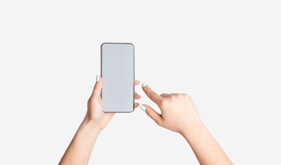 Unrecognizable young girl showing smartphone with empty screen on white background, mockup for mobile app design