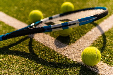 Tennis Racket on empty tennis grass court