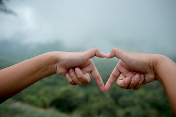 Tourists mark their hands Behind the mountain view, the location of Pha Mor E Daeng