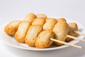 Fish cake skewer, isolated on white background.
