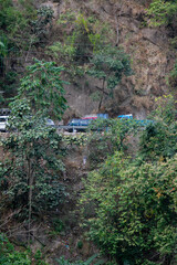 vehicles passing risky hilly tracks at Sevok in India.