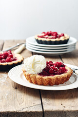 Baked mini tarts with raspberries.