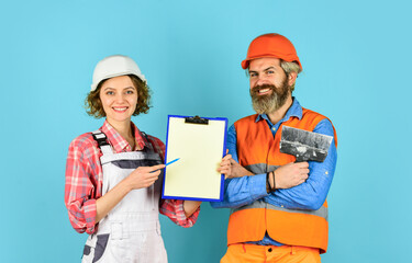 Price list. Couple look documents. Couple planning changes renovation apartment. Renovation...