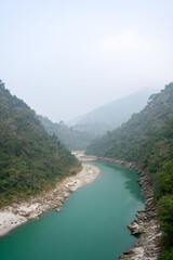 Fototapeta na wymiar River of green water through mountains.