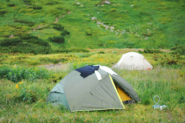 Tourist tent in camp among meadow in the mountain