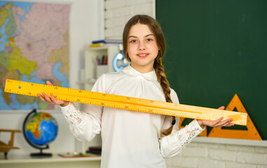 Learning to use ruler. back to school. High school student learning geometry in class. measure...