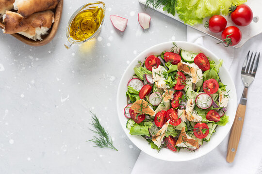 Delicious vegetarian Fattoush or Arab salad with pita bread, fresh vegetables on plate. Middle Eastern bread salad