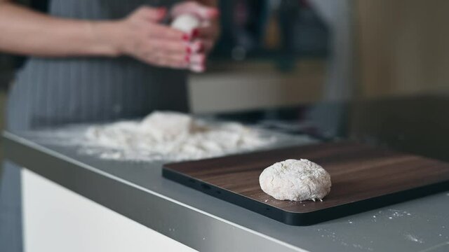 Close-up of a tasty cutlets, a female cook cooks meatballs, dipping cutlets of minced meat in flour and spreading it on a baking tray.