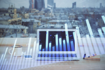 Financial chart drawing and table with computer on background. Multi exposure. Concept of international markets.