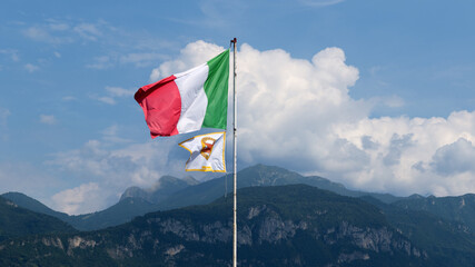 Italian flag standing on the Alps mountain.