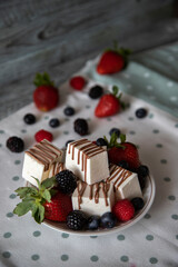 dessert poured with chocolate with berries on a white saucer