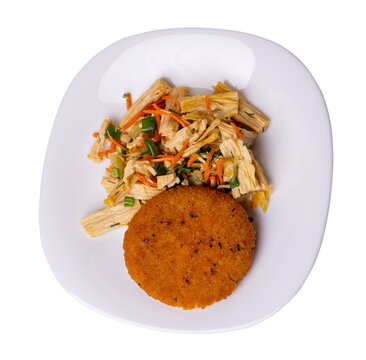 fishcake with soy asparagus and carrots, cucumbers and dilll. fish cutlet on a plate isolated. cutlet with vegetables top view