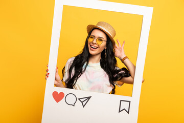 happy brunette girl in summer outfit posing in social network frame on yellow background