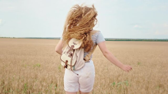 Running in the middle of wheat field beautiful lady from the country side she feeling freedom and enjoying the time with herself