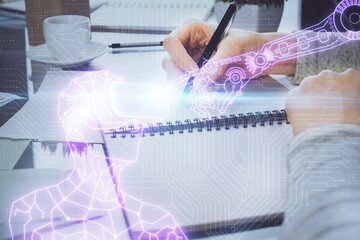 AR hologram over hands taking notes background. Concept of augmented reality. Double exposure