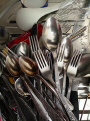 vintage forks and spoons in a pile in the kitchen