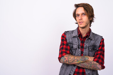 Young handsome rebellious man against white background