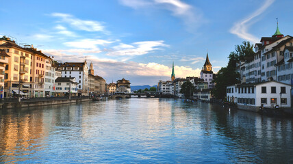Fototapeta na wymiar Switzerland: Zurich river Limmat landscape at sunset, view on the old buildings of the city