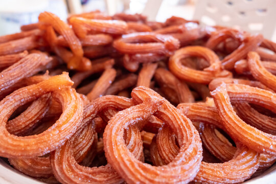 Turkish Dessert Churros Halka Tatli frying in hot oil.