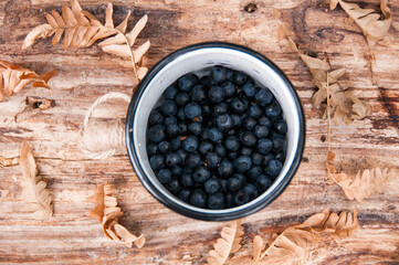 Blueberries in mug on wooden background. Healthy food concept. Natural food concept. Berry 
